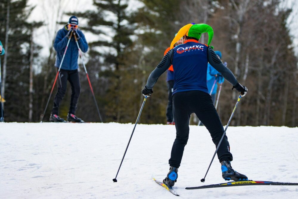 a group of people riding skis down a snow covered slope